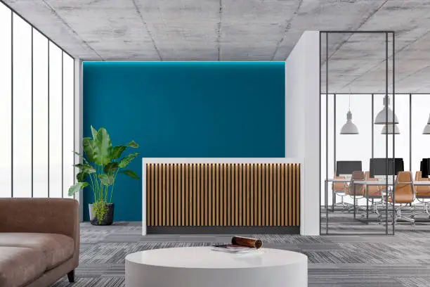 Office reception area with a bold teal accent wall and durable neutral finishes, by an interior painter in Kansas City, MO.